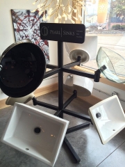 A sink rack showcasing various sinks, emphasizing practicality and order in a commercial or industrial environment.