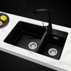 Modern black kitchen sink paired with a stunning marble countertop, highlighting a sophisticated culinary space.
