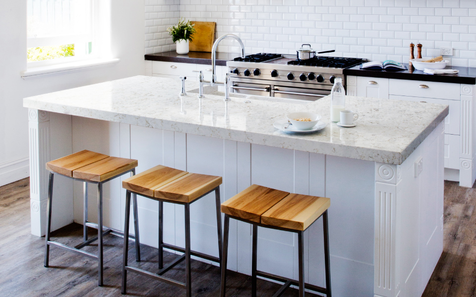 Contemporary kitchen with pristine white cabinets and a luxurious marble island, enhancing the space's elegance and functionality.