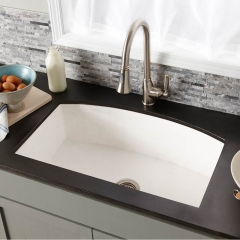 A modern kitchen sink set against a sleek black countertop, showcasing a stylish and functional design.