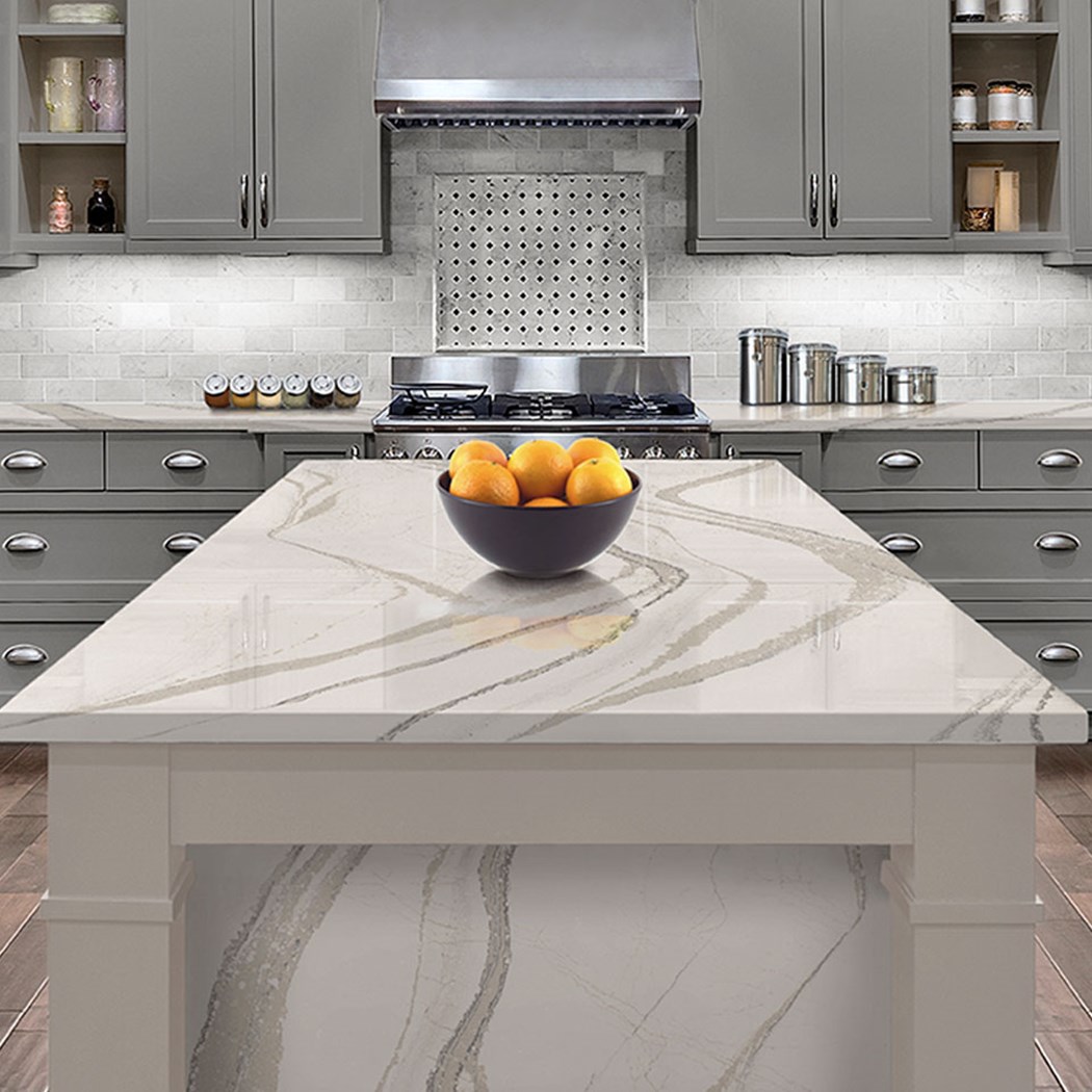 A contemporary kitchen showcasing pristine white marble countertops paired with sleek gray cabinets for a chic design.