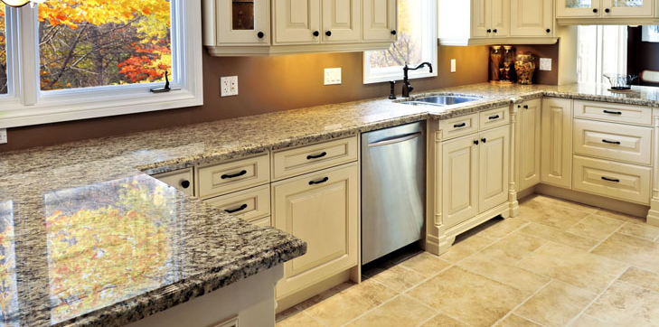 Contemporary kitchen design with polished granite countertops and classic white cabinets, offering a clean and sophisticated look.