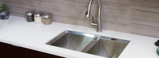 A sleek modern kitchen sink featuring a polished stainless steel faucet, showcasing contemporary design and functionality.